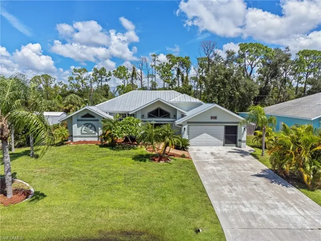View of front of home with a garage and a front yard
