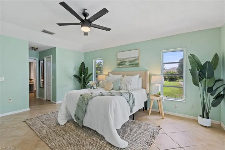 Bedroom featuring light tile patterned floors and ceiling fan