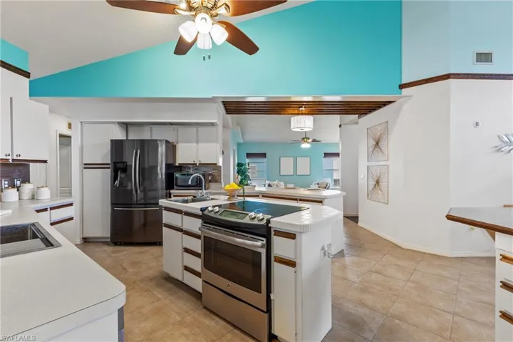 Kitchen featuring white cabinets, appliances with stainless steel finishes, and ceiling fan