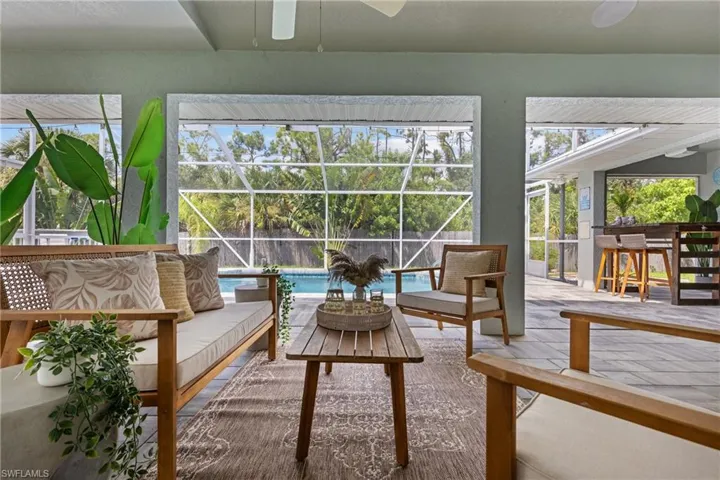 Sunroom featuring a wealth of natural light and ceiling fan