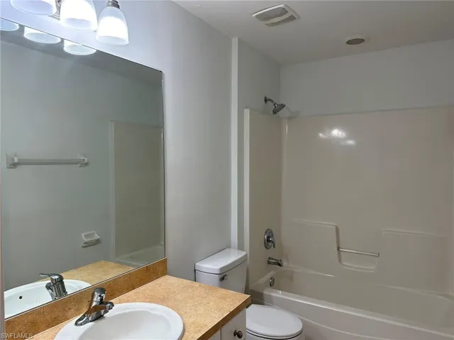 Full bath with vanity and bathtub / shower combination