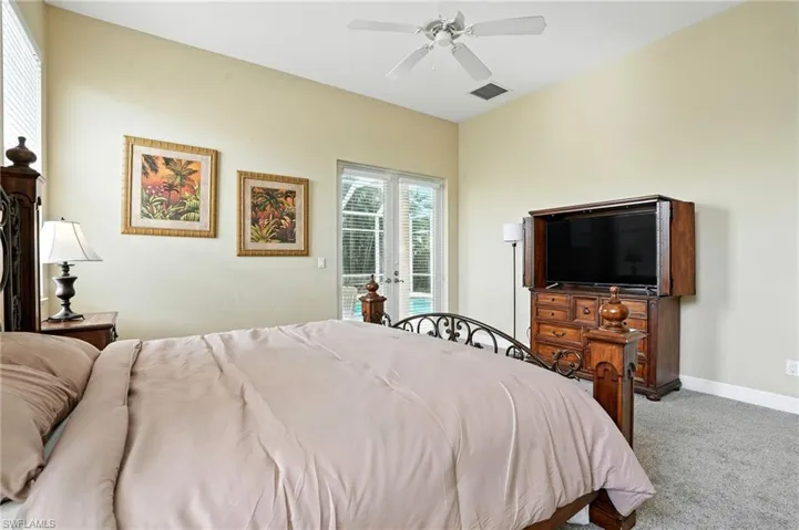Bedroom featuring carpet flooring, ceiling fan, and access to exterior