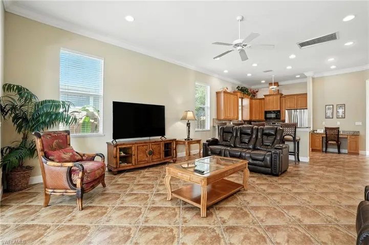 Living area featuring crown molding, recessed lighting, a ceiling fan, and light tile patterned flooring