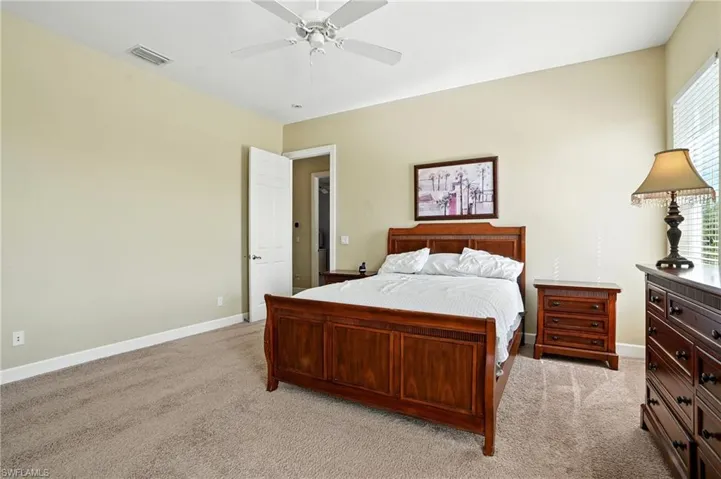Bedroom featuring light carpet and ceiling fan