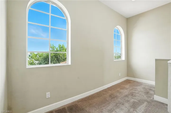 Empty room with carpet and baseboards