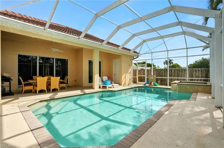 View of pool featuring a patio, a sunroom, ceiling fan, a lanai, and a pool with connected hot tub