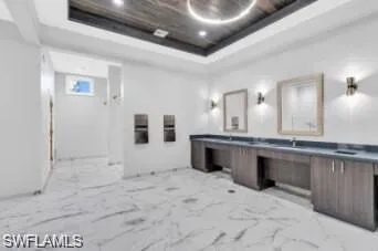 Bathroom featuring vanity and a raised ceiling