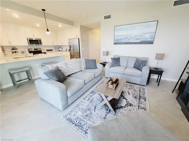 Living room with light tile patterned floors