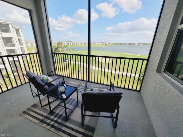 Sunroom featuring a water view