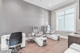 Office area with a healthy amount of sunlight and light hardwood / wood-style flooring