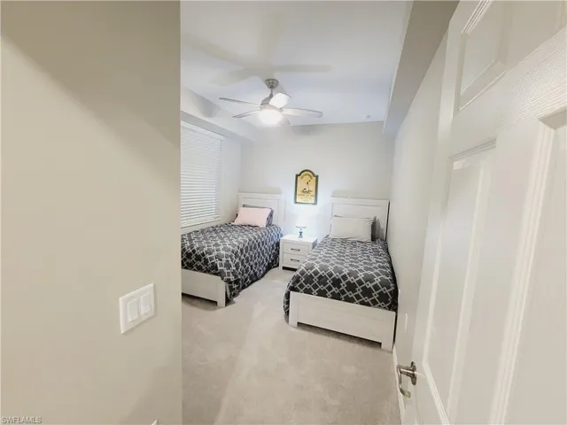 Carpeted bedroom with ceiling fan