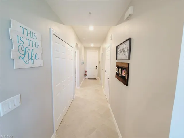 Corridor with light tile patterned floors