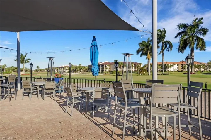 View of patio with outdoor dining space and view of golf course