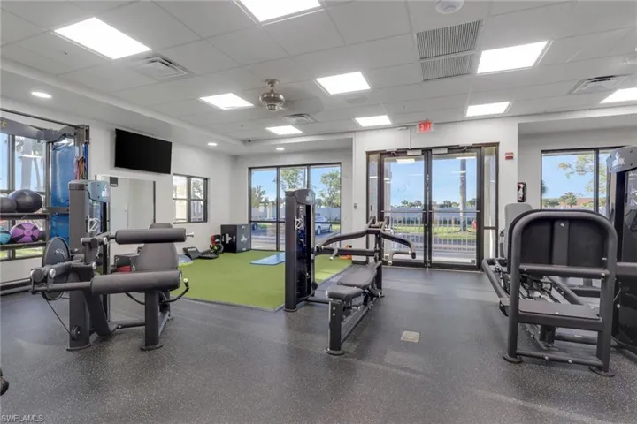 Workout area featuring a drop ceiling and a ceiling fan