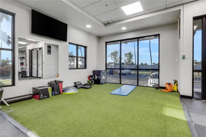 Playroom with a drop ceiling and an area to practice putting