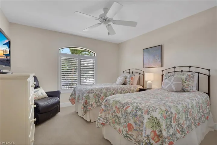 Bedroom with light carpet and ceiling fan