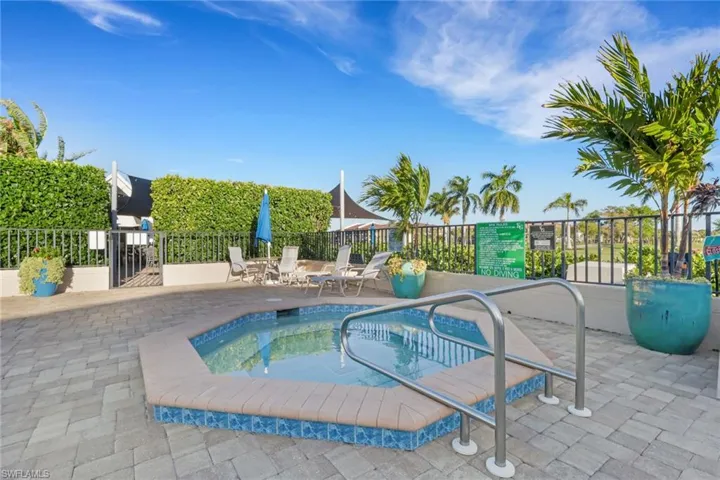 View of swimming pool featuring a swimming pool, patio surround, and a hot tub