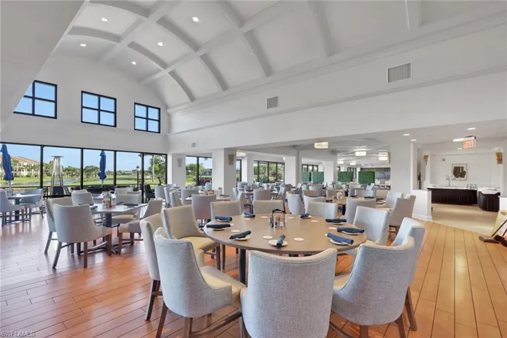 Dining area with light wood finished floors, recessed lighting, and lofted ceiling