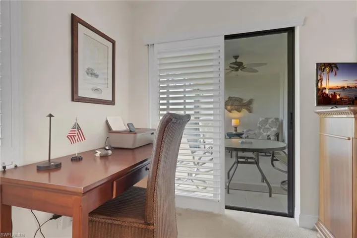 Office with a ceiling fan and carpet floors
