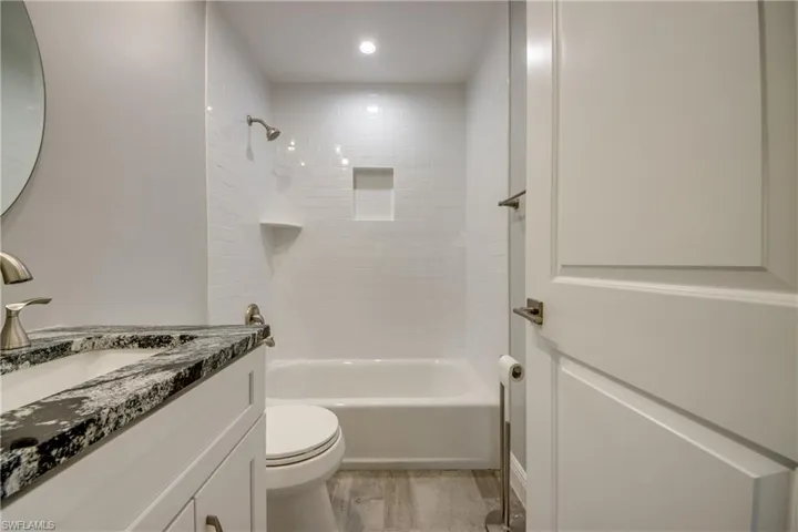 Full bathroom featuring vanity, toilet, and tiled shower / bath