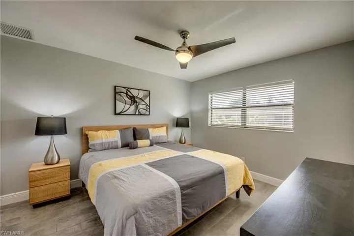 Bedroom with hardwood / wood-style floors and ceiling fan
