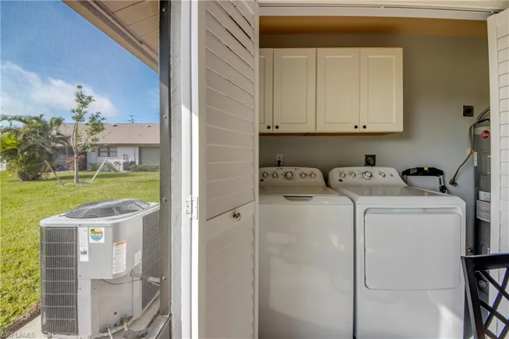 Laundry area with cabinets and washing machine and clothes dryer