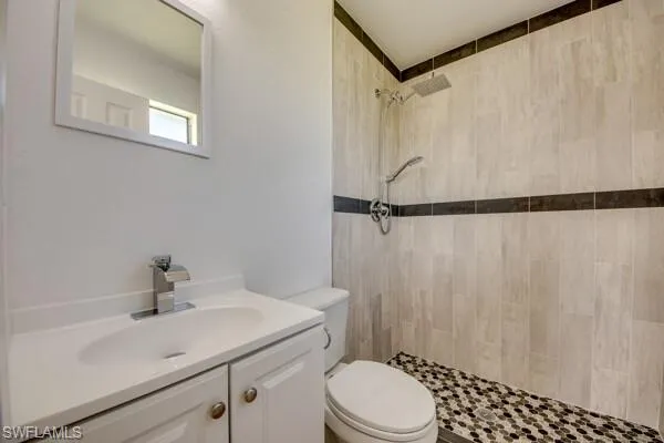 Full bath with vanity and tiled shower