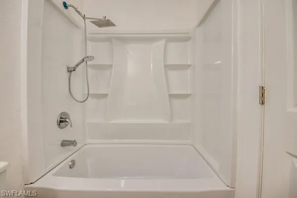Bathroom featuring toilet and shower / tub combination