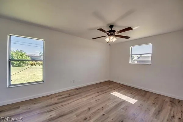 Unfurnished room with light wood-style flooring and ceiling fan