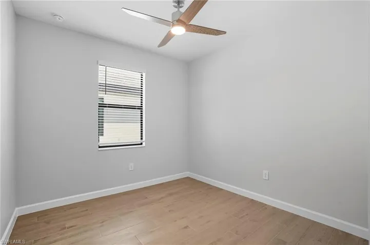 Spare room featuring light wood-style floors and a ceiling fan