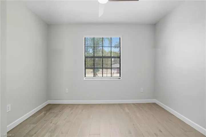 Unfurnished room featuring light wood finished floors and a ceiling fan