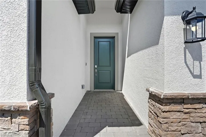 Property entrance with stucco siding