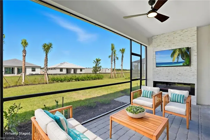 Sunroom featuring an outdoor living space with a fireplace and ceiling fan