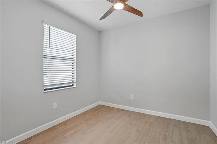 Spare room featuring light wood-style flooring and ceiling fan