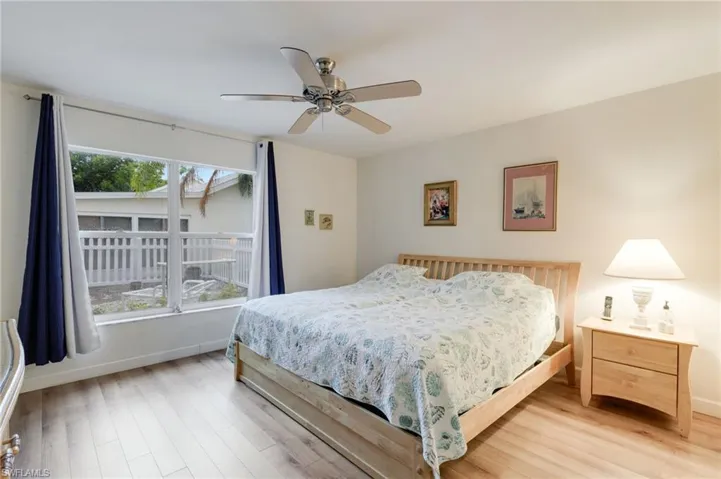 Primary Bedroom with ceiling fan and wood-style floors