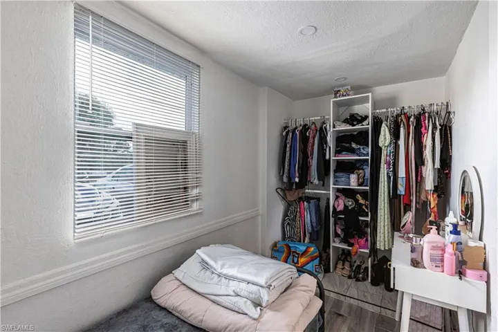 Unit B)Walk in closet with wood finished floors