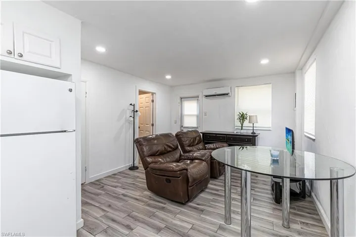Unit C)Living room featuring wood tiled floors and recessed lighting