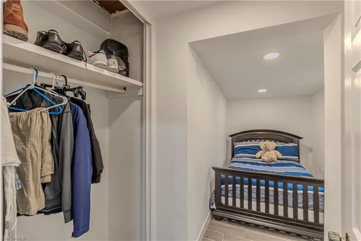 Unit C)Bedroom featuring recessed lighting and wood finish floors