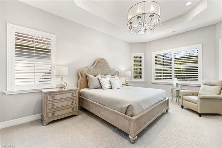 Large master suite with plantation shutters, 2 walk-in closets, and sittting area