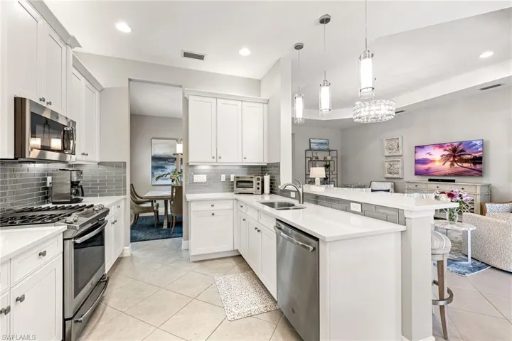 Stainless steel appliances and spacious kitchen.