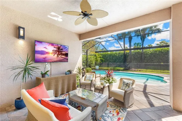 Covered lanai area with TV and plenty of covered seating area space.