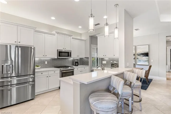 Upgraded stainless steel appliances, quartz contertops, counter seating