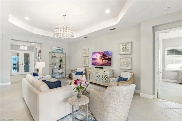 Open living space with sliders to covered lanai and pool.