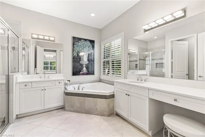 Dual sinks, large soaking tub, light and bright.