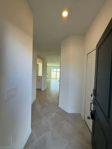 Hallway featuring baseboards
