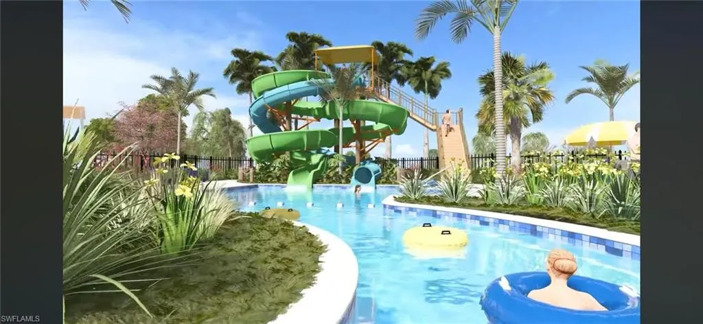 Community pool featuring a water slide and a patio area