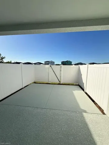 Fenced backyard featuring a gate