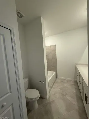 Full bathroom with vanity and toilet