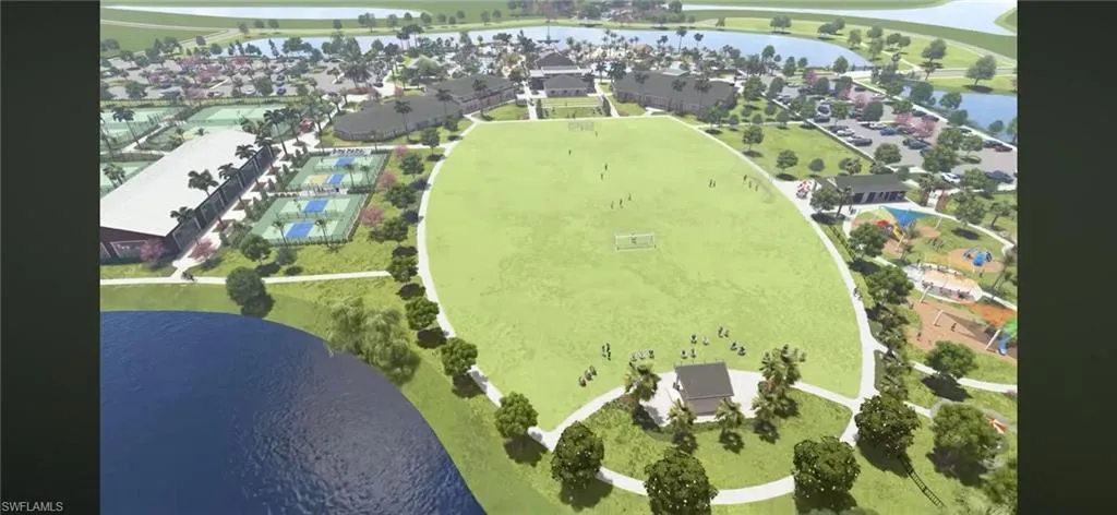 Aerial view of residential area featuring a large body of water, a golf course, and property boundaries highlighted