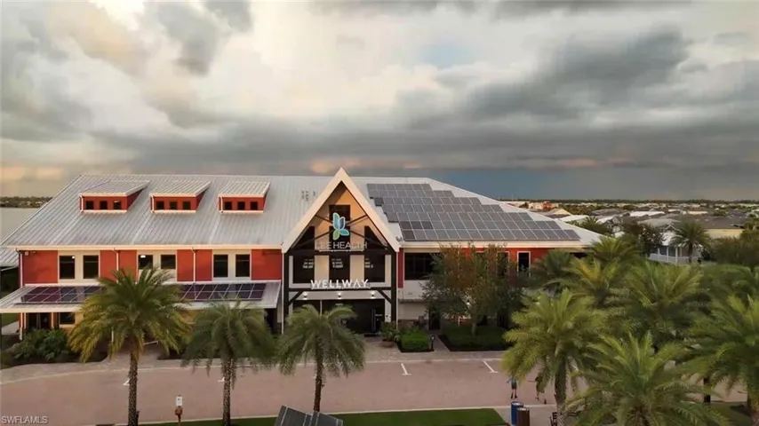 View of front of home with a balcony and roof mounted solar panels
